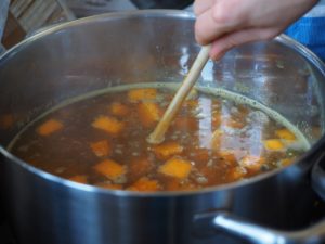 stirring pot of soup